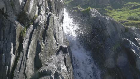 Fresh-clean-water-stream-cascading-down-rocks-in-the-Swiss-Alps,-in-Slow-Motion