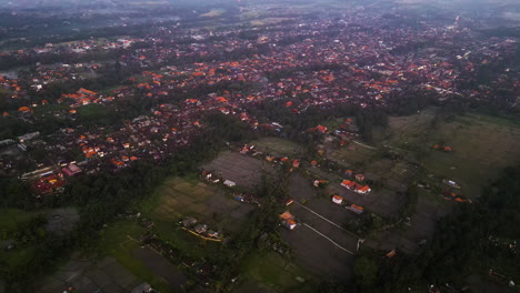 Aerial-at-dusk-over-Ubud,-Bali,-Indonesia,-showing-the-increased-urban-expansion-due-to-unrestricted-tourism