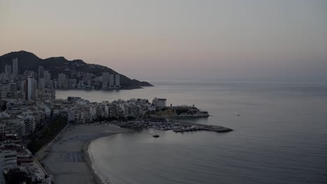 Mediterranean-first-light-time-lapse,-wide-view,-Benidorm-beach-and-coastline-from-above-4K