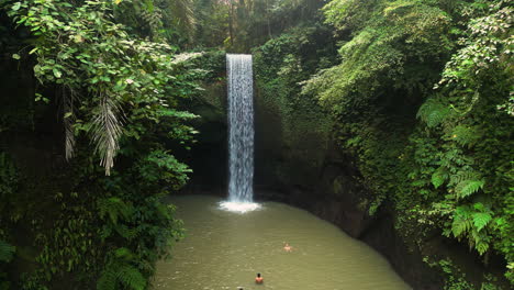 Aerial-View-of-People-Swimming-at-Tibumana-Waterfall-in-Bali