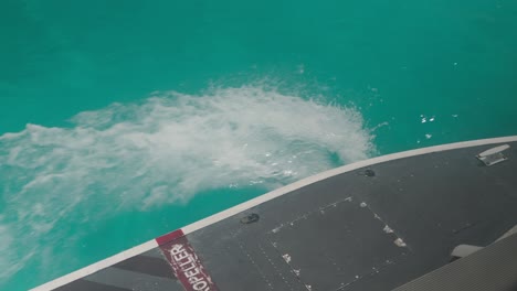 Seaplane-float-splashing-water-on-surface-of-blue-tropical-sea,-buoyancy