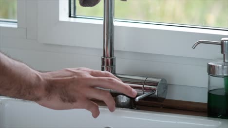faucet-in-the-kitchen-with-running-water