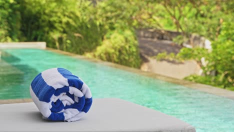 Pool-towel-sitting-on-sun-lounger-at-luxury-hotel-room