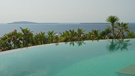 Slow-calming-pan-over-the-infinity-pool-with-views-across-the-Gilli-islands-in-Indonesia
