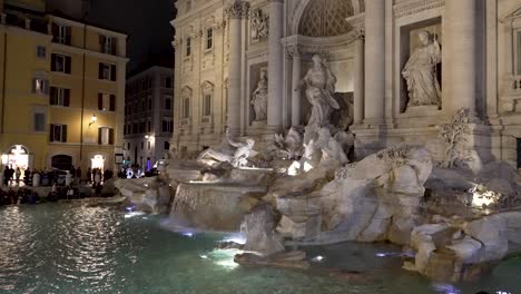 Side-View-Of-Illuminated-Trevi-Fountain-In-The-Evening-Viewed-From-Via-della-Stamperia