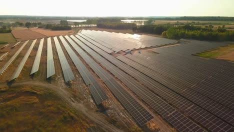aerial-of-solar-panel-base-station-in-countryside-during-sunshine-golden-hours-warm-light-zero-emission-green-renewable-energy-concept