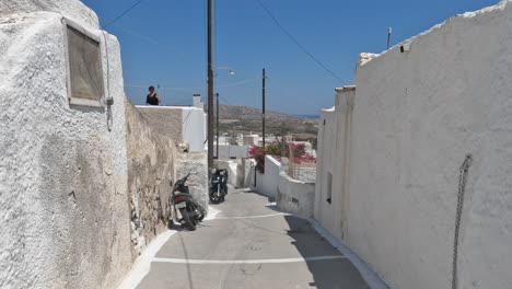 POV-handheld-walking-shot-through-the-backstreets-of-the-Greek-island-town-of-Akrotiri,-in-Santorini-Greece