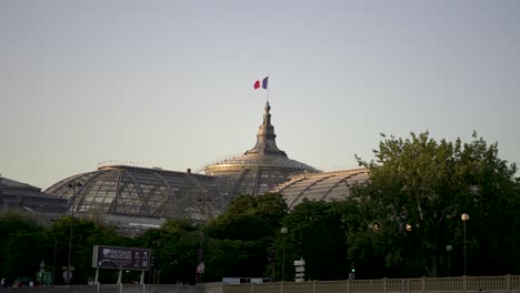 Grand-Palais-with-French-flag-seen-from-the-river-Seine,-View-from-boat