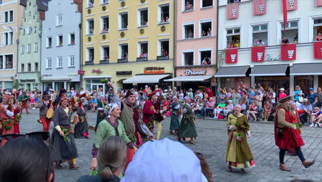 Dancing-farmers-in-costumes-at-the-Parade-at-the-Landshut-wedding,-a-historical-celebration-of-1475-that-is-reenacted-every-4-years,-Landshut,-Germany