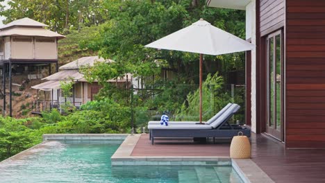 Spending-the-day-poolside-with-sun-loungers-in-front-of-the-private-villa