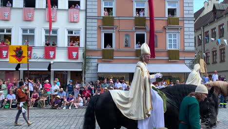 Duke-in-costume-riding-on-horse-and-greeting-people-at-the-Parade-at-the-Landshut-wedding,-a-historical-celebration-of-1475-that-is-reenacted-every-4-years,-Landshut,-Germany