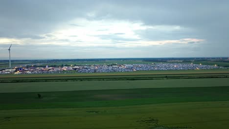 Panoramic-View-Of-Green-Fields-And-Huge-Crowd-During-The-Event-Nova-Rock-Festival-In-Nickelsdorf,-Austria---drone-shot