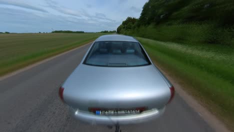 Hyperlapse-Shot-of-Silver-Sedan-Car-Driving-On-Road