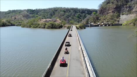SIDE-BY-SIDE-over-bridge,-long-bridge-over-lake,-CAN-AM,-UTV-Off-Road-Extreme-Racing,-Rally-race,-Polaris,-SIDE-BY-SIDE,-SXS,-ATV