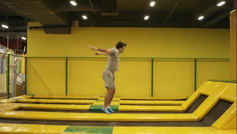 Beautifuly-performed-back-somersault-with-the-folowing-full-twisting-double-picked.-Young-athletic-male-enjoying-jumping-on-trampoline.
