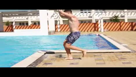 Young-athletic-man-in-swim-shorts-running-and-jumping-spinning-to-the-swimming-pool.-Slowmotion-shot.