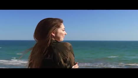 Woman-with-long-hair-enjoying-the-sea-view-outside.-Slowmotion-shot