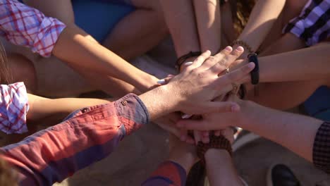 Close-Up-view-of-many-hands-together-united-in-support.-Teamwork-and-friendship-concept.-Slow-Motion-shot