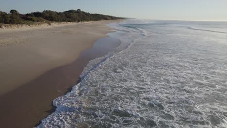 Foamy-Waves-Splashing-Sandy-Shore-Of-Coolum-Beach-In-Sunshine-Coast-Region,-Queensland,-Australia---aerial-drone-shot