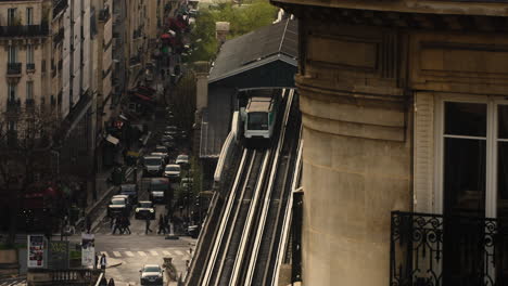 Train-Departing-From-Station-With-View-Of-Daytime-Traffic-And-Crossing-Pedestrians-In-Paris,-France