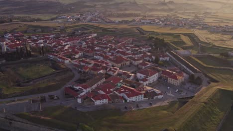 Side-panning-shot-of-touristic-village-Almeida-Portugal-in-the-morning,-aerial