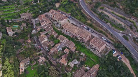Small-houses-at-Deia-in-the-Tramuntana-Mountains-of-Mallorca,-aerial