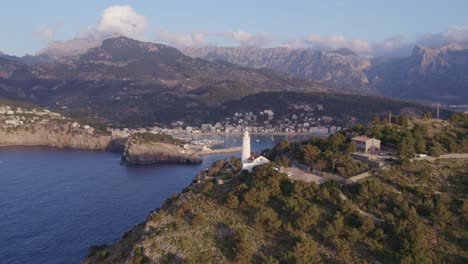 Port-Sóller-in-the-north-coast-of-Mallorca-with-mountain-background-low-clouds,-aerial