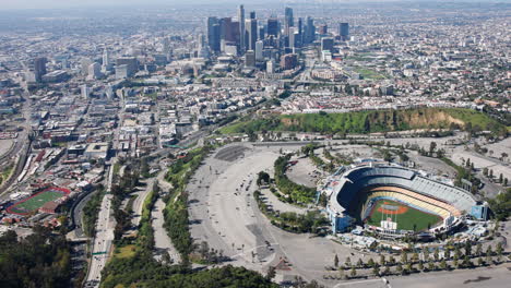 Aerial-Dodger-Stadium-afternoon-on-an-helicopter-wide-shot-Downtown-Los-Angeles-on-the-distance