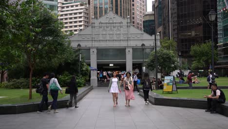 People-saunter-at-Raffles-Place,-a-financial-district-in-the-heart-of-Singapore's-Central-Business-District-
