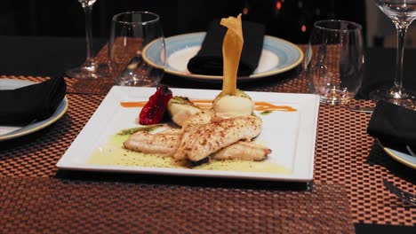 Plate-of-salmon-with-mustard-sauce-at-the-table-with-crystal-wine-glasses-in-a-fancy-restaurant
