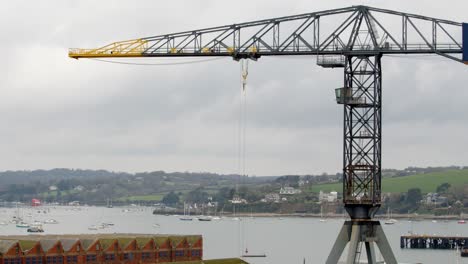 wide-shot-Looking-over-the-docks-on-Pendennis-rise,-with-moving-dock-crane-and-Flushing-in-background