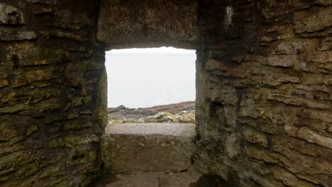 Looking-though-Window-opening-at-Castle-Fort,-Falmouth-with-Sea-in-the-background