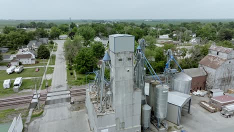 Grain-elevator-in-downtown-State-Center,-Iowa-with-drone-video-moving-in-a-circle