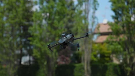 Stationary-Mavic-quadcopter-drone-suspended-in-air-tilts-nose-and-flies-away