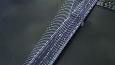 High-aerial-angle-of-suspension-bridge-over-river-with-road-traffic-in-dramatic-light