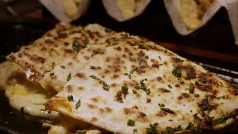 A-mouthwatering-close-up-reveals-the-delectable-details-of-quesadillas,-showcasing-their-golden,-cheesy-perfection-and-enticing-flavor