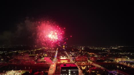 Des-Moines,-Iowa-fireworks-over-city-and-state-capitol-building-on-Independence-Day-with-drone-video-moving-in-wide-shot