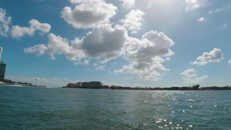 view-from-a-boat-on-the-calm-water-of-Biscayne-bay-Florida-with-blue-sky-and-fluffy-clouds