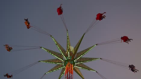 Iconic-sky-flyer-festival-ride,-swinging-up-high-in-the-sky-at-Ekka-Brisbane,-Royal-Queensland-Show,-Australia