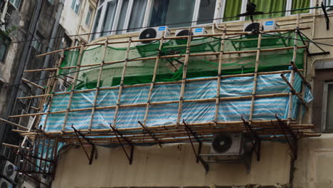 Close-up-shot-of-a-construction-site-on-the-side-of-a-building-with-air-conditioning-in-Hong-Kong