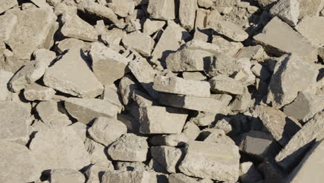 Panning-Close-Up-of-Rocks-and-Concrete-from-a-Demolished-Building