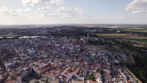 Establishing-shot-of-Badajoz-cityscape-with-Alcazaba-ancient-citadel,-Orbiting-shot