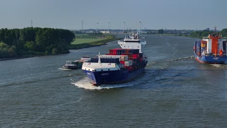 Cargo-Ship-Laden-with-Containers-Sailing-Down-the-River,-orbit-drone-shot