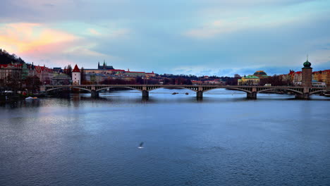 Jirásek-bridge-over-Vltava-river-in-Prague-with-city-skyline-at-dusk