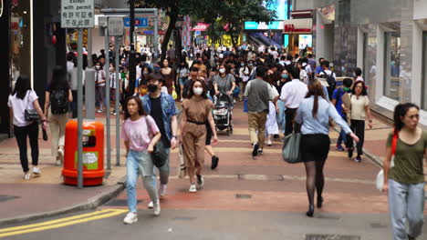 Tatic-shot-of-people-walking-along-a-busy-street-in-an-Asian-city