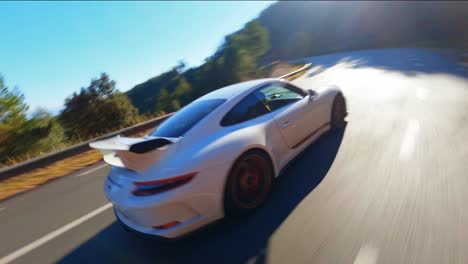 Epic-FPV-aerial-drone-following-a-white-Porsche-911-through-the-scenic-hills-of-Spain