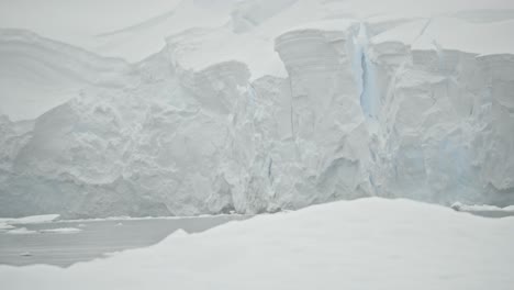 Coastline-with-ice-and-snow,-big-glacier-and-iceberg