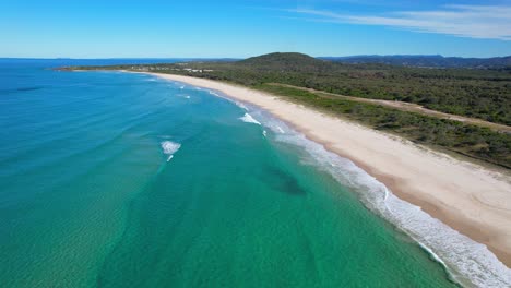White-Sand-and-Turquoise-Waters-of-Maggies-Beach,-Cabarita,-Northern-Rivers,-Tweed-Shire,-Bogangar,-New-South-Wales,-Australia,-Aerial-Pull-Back