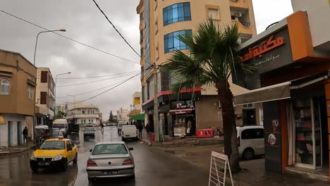 Driving-through-Tunisian-town-of-Medenine-or-Médenine-on-cloudy-rainy-day