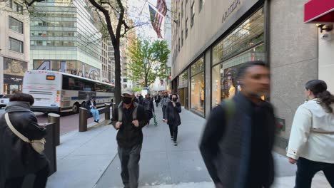 First-person-view-of-people-walking-in-5th-Avenue-busy-street-of-Manhattan-financial-district-in-New-York-City,-USA